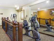 The exersize room shows cardio machines for guest use.